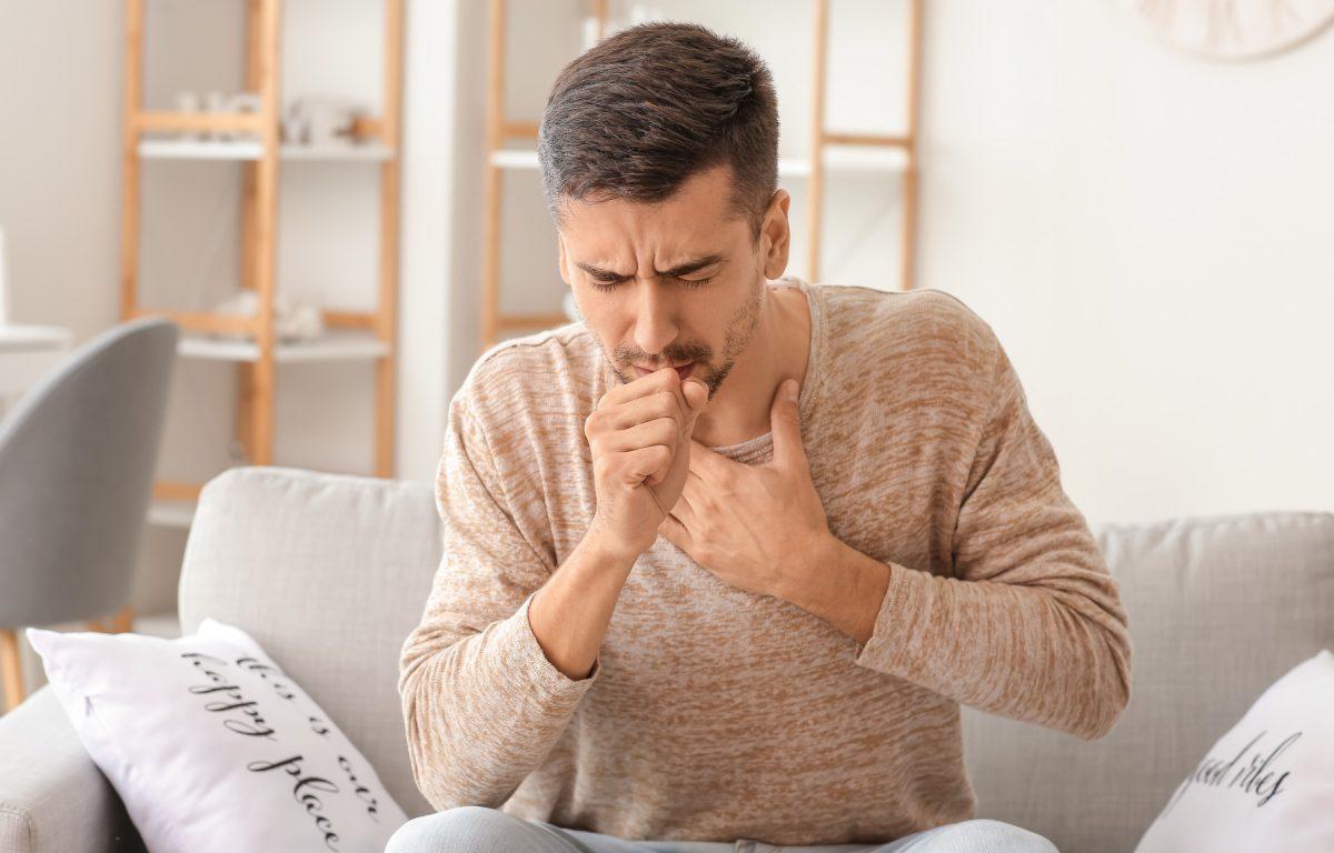 man coughing sick illness covid coronavirus flu influenza