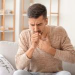 man coughing sick illness covid coronavirus flu influenza