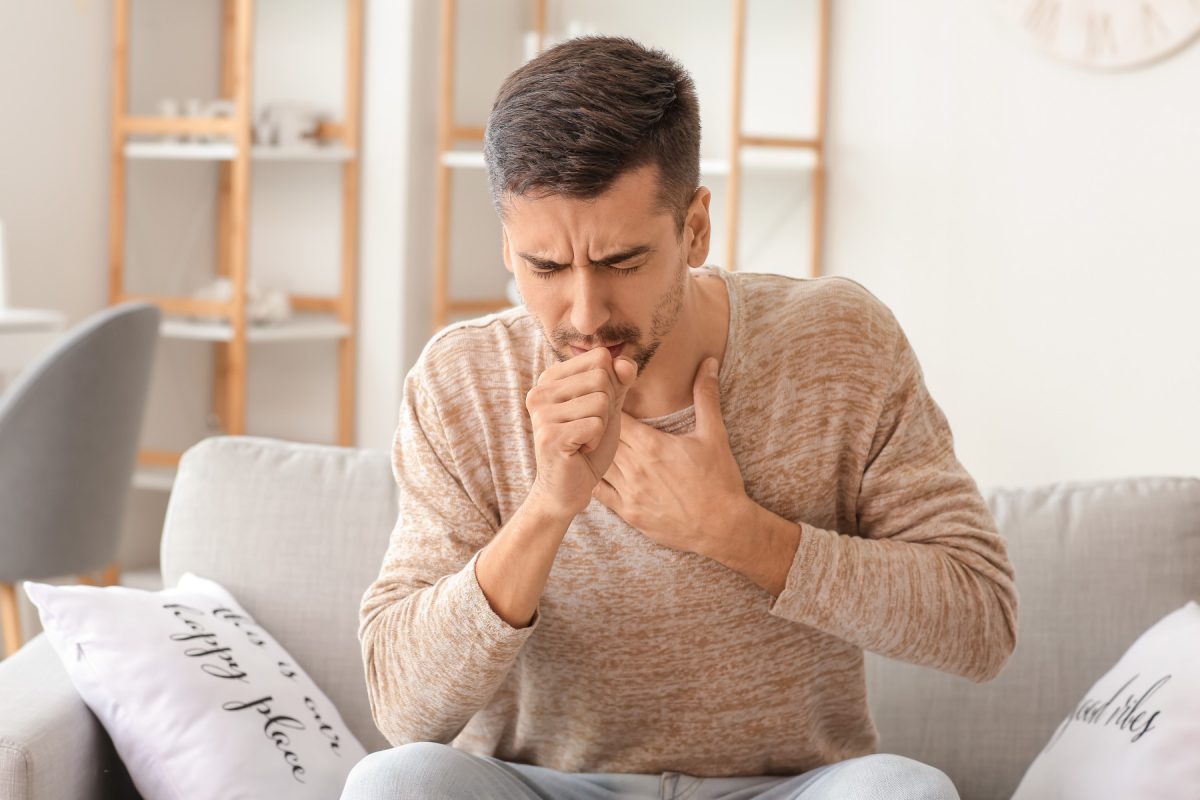 man coughing sick illness covid coronavirus flu influenza