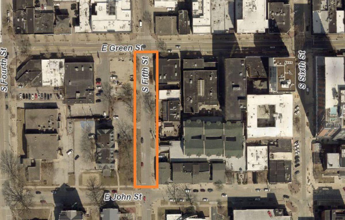 Aerial view of a city block with an orange vertical outline along S Fifth Street between E Green Street (top) and E John Street (bottom).