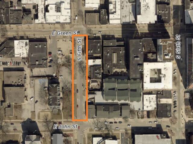 Aerial view of a city block with an orange vertical outline along S Fifth Street between E Green Street (top) and E John Street (bottom).