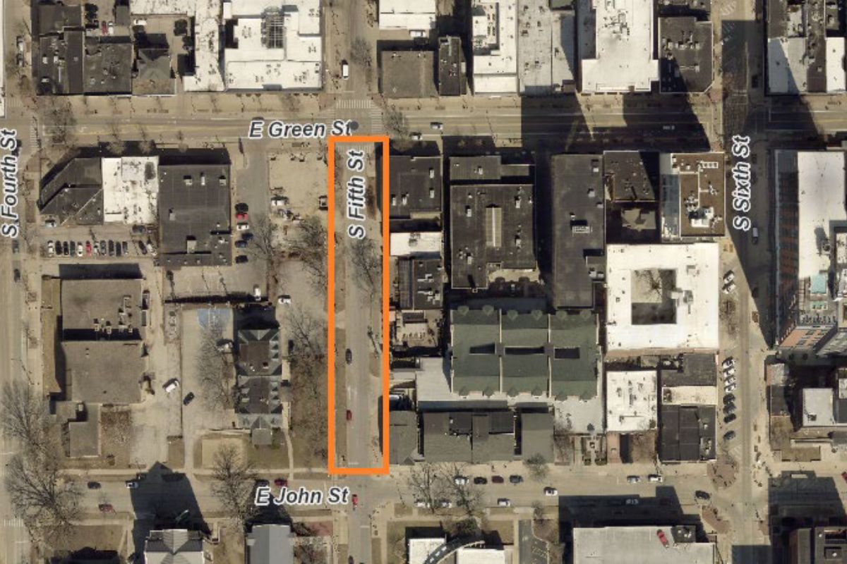 Aerial view of a city block with an orange vertical outline along S Fifth Street between E Green Street (top) and E John Street (bottom).