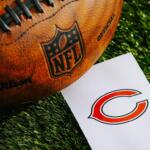 Orange NFL football on grass beside a white card with the Chicago Bears logo