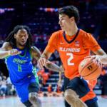 Illinois player in orange #2 dribbles with the ball as FGCU defender in blue #1 pursues.