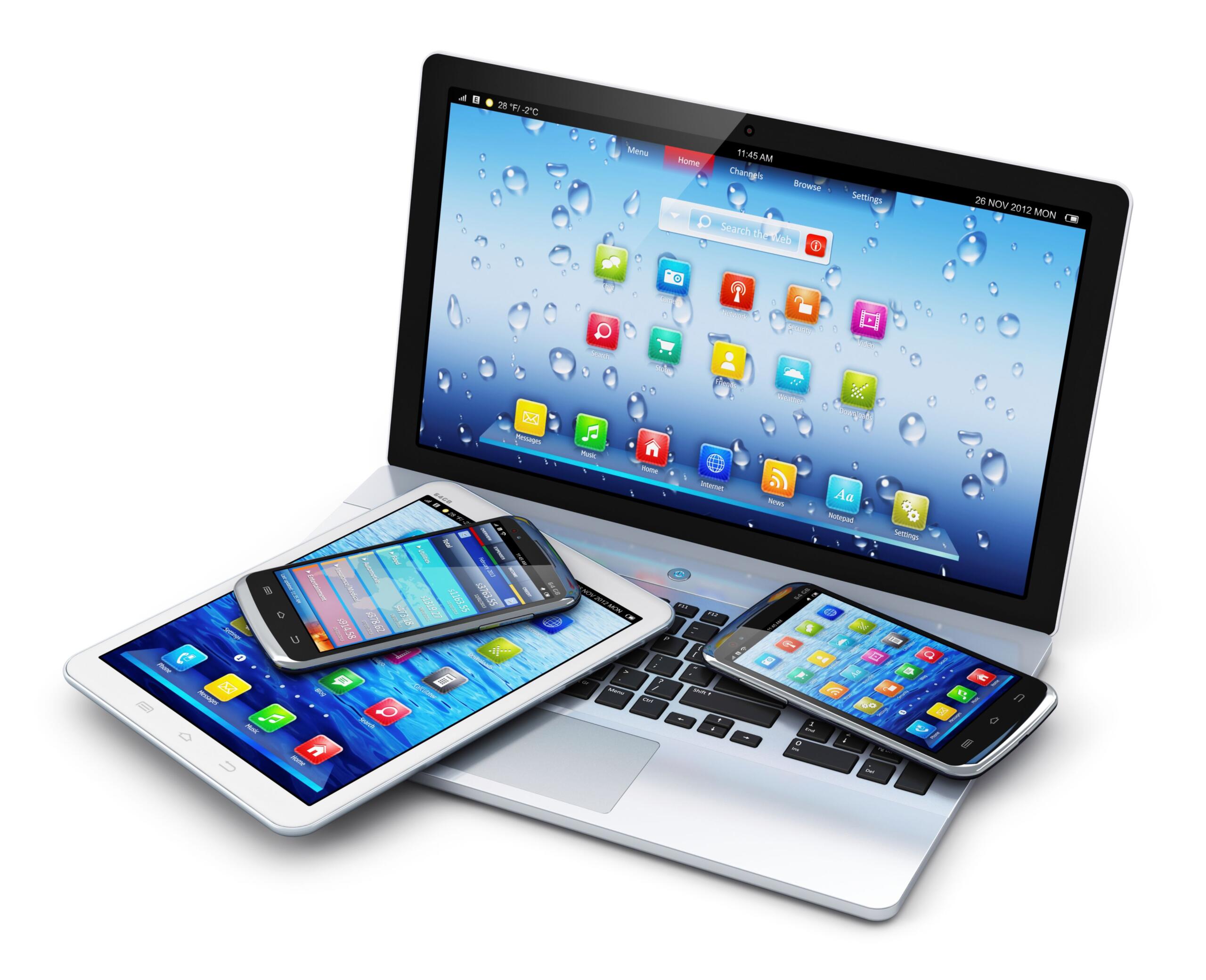 Angled group of tablets and smartphones resting on a laptop keyboard, screens filled with colorful app icons.
