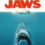 Poster for Jaws: a great white shark breaches upward toward a swimmer at the surface in blue ocean water.
