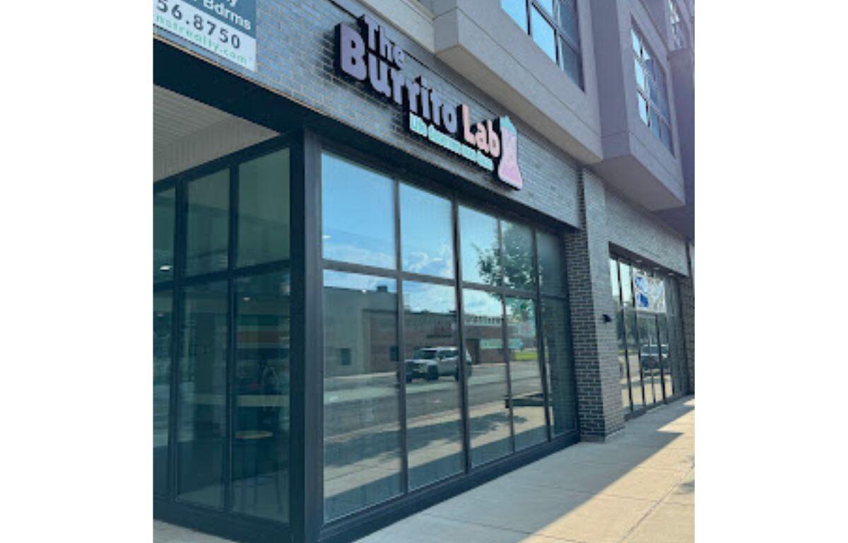 Exterior storefront with large glass windows and a brick facade; sign above reads 'Buffalo Lab' (storefront on a sunny day)