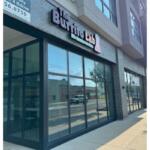 Exterior storefront with large glass windows and a brick facade; sign above reads 'Buffalo Lab' (storefront on a sunny day)