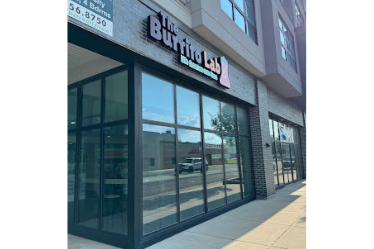 Exterior storefront with large glass windows and a brick facade; sign above reads 'Buffalo Lab' (storefront on a sunny day)
