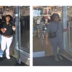 Two women exit a clothing store through glass doors; left woman smiles, wearing a black top and white pants, holding a card. Right woman in gray outfit with a black crossbody bag exits beside her.