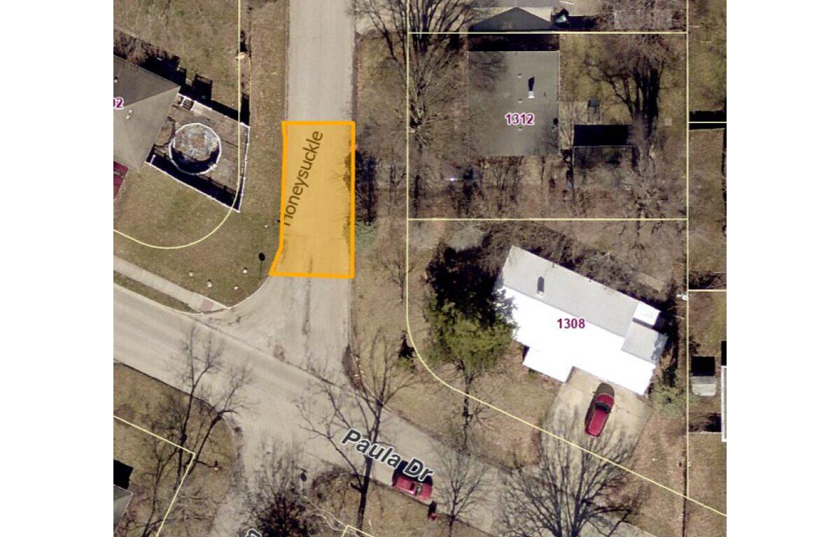 Aerial view of a residential street with property boundaries; orange highlighted lot along Honeysuckle Lane between 1312 and the driveway.