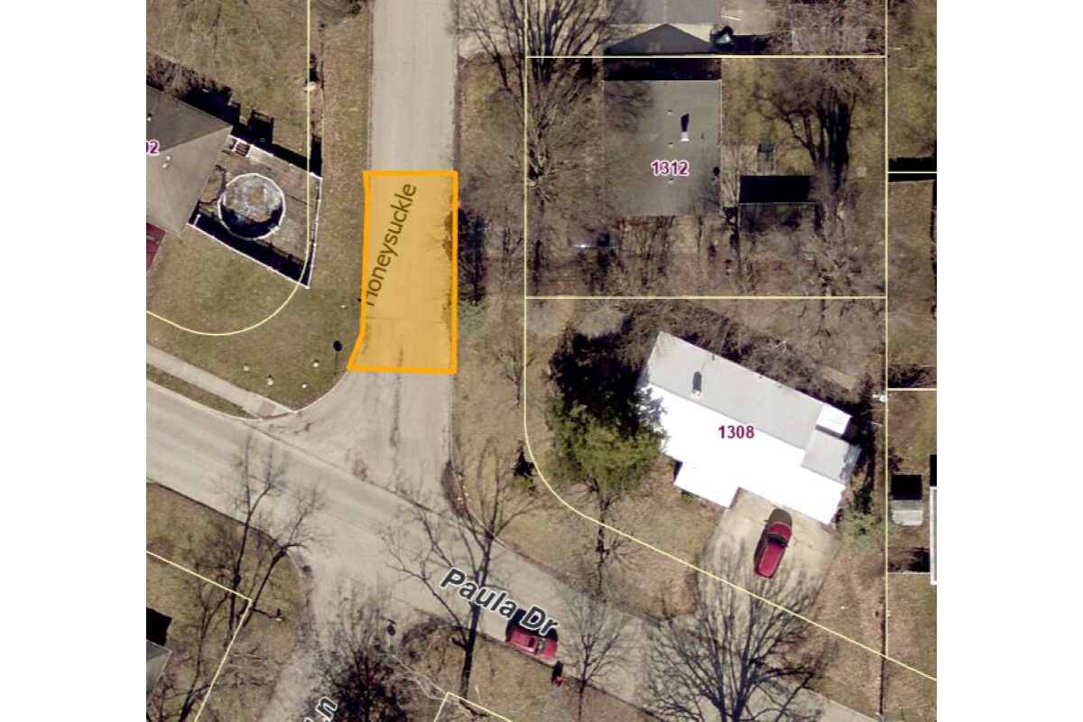 Aerial view of a residential street with property boundaries; orange highlighted lot along Honeysuckle Lane between 1312 and the driveway.