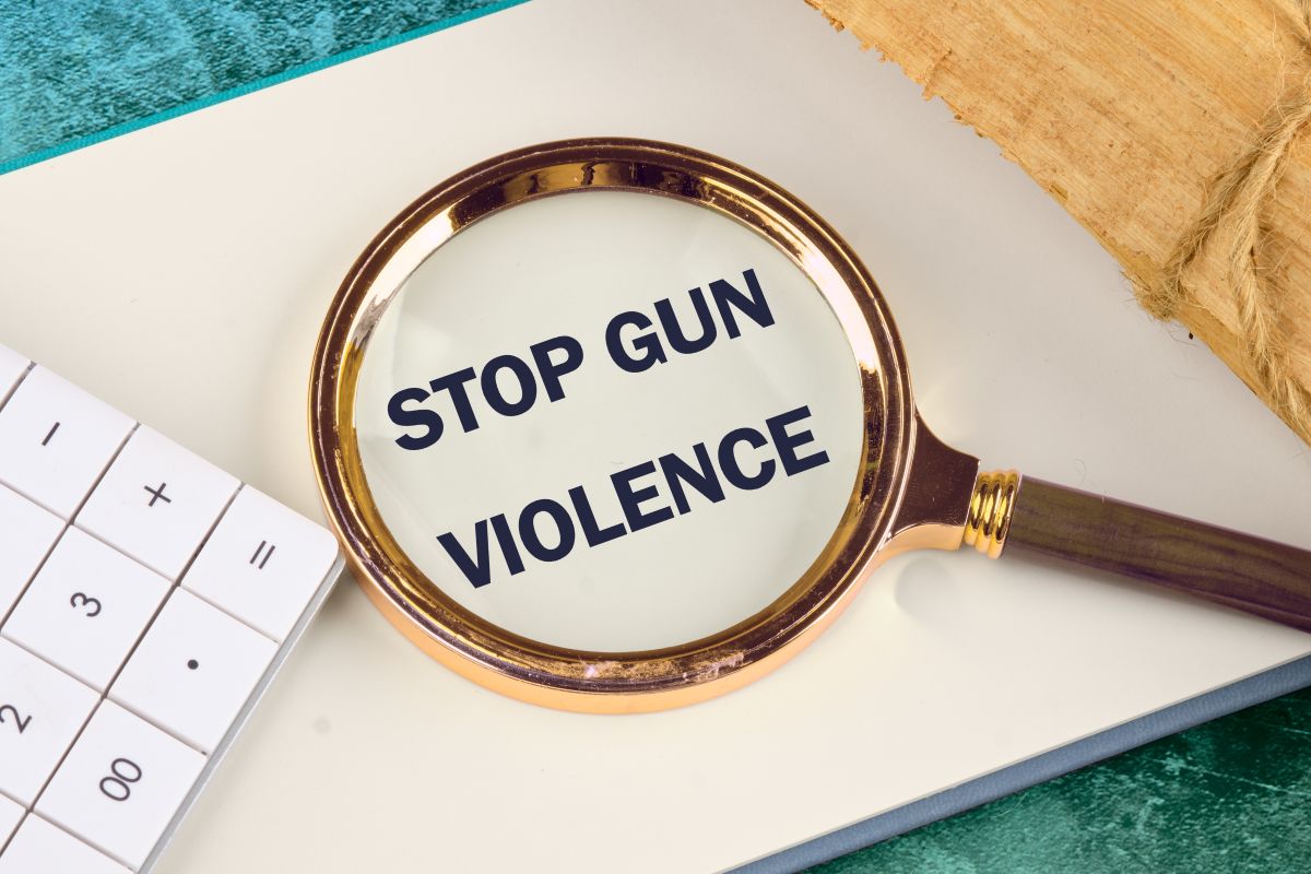 Magnifying glass over a white page displaying the message Stop Gun Violence.