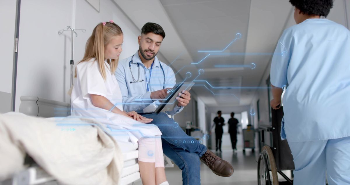 Doctor and patient sit on a hospital bed as the doctor reviews a tablet, with blue holographic medical circuit graphics overlaying the scene.