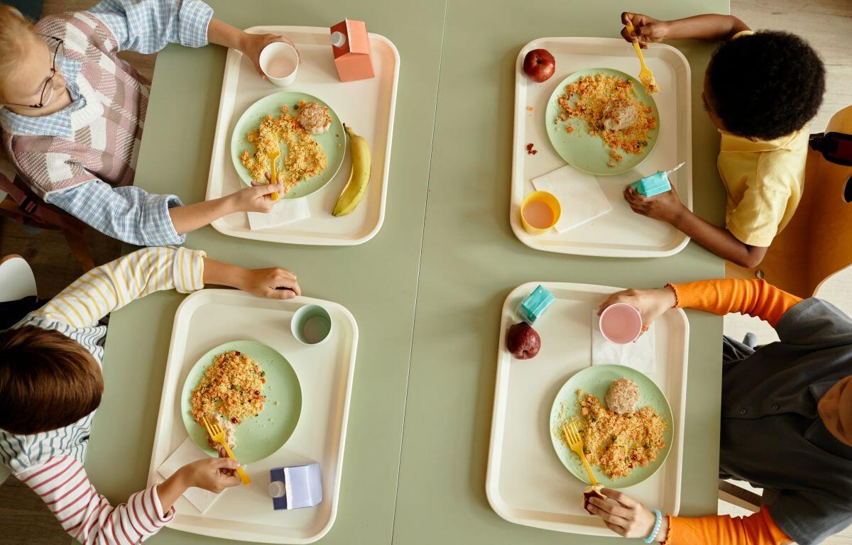 Four kids at a cafeteria. Cunningham Children's Home is renovating their cafeteria and fundraising to pay for it.