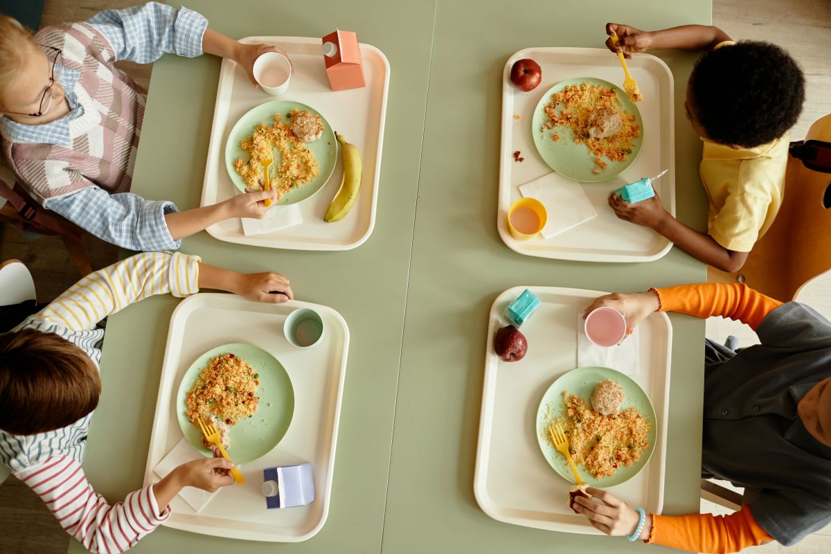 Four kids at a cafeteria. Cunningham Children's Home is renovating their cafeteria and fundraising to pay for it.