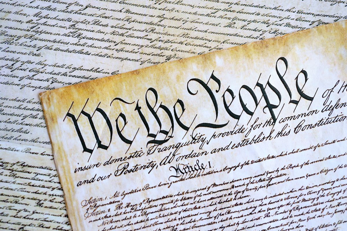 The U.S. Constitution scroll with the words 'We the People' in calligraphic script, part of a historical document display.