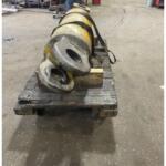 Large yellow industrial hose reel strapped to a wooden pallet in a workshop.